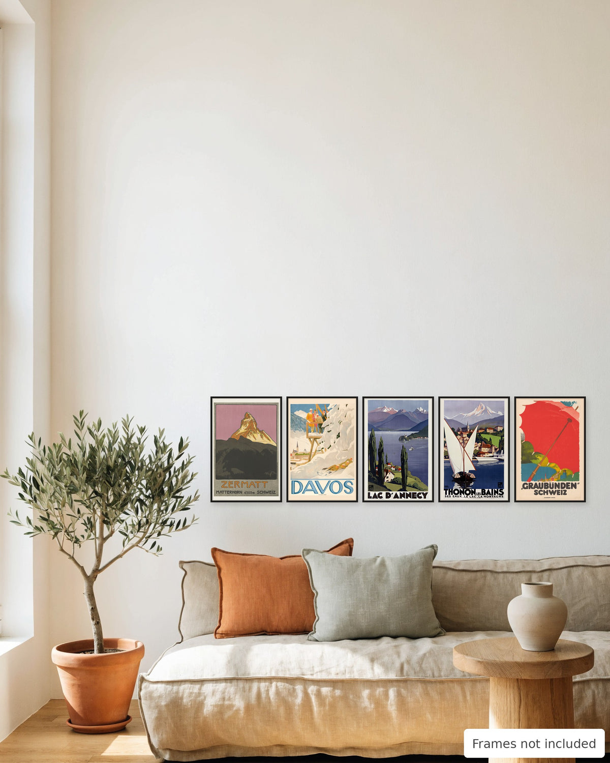 Alps vintage travel poster set of 5 hung as a gallery wall above a linen sofa