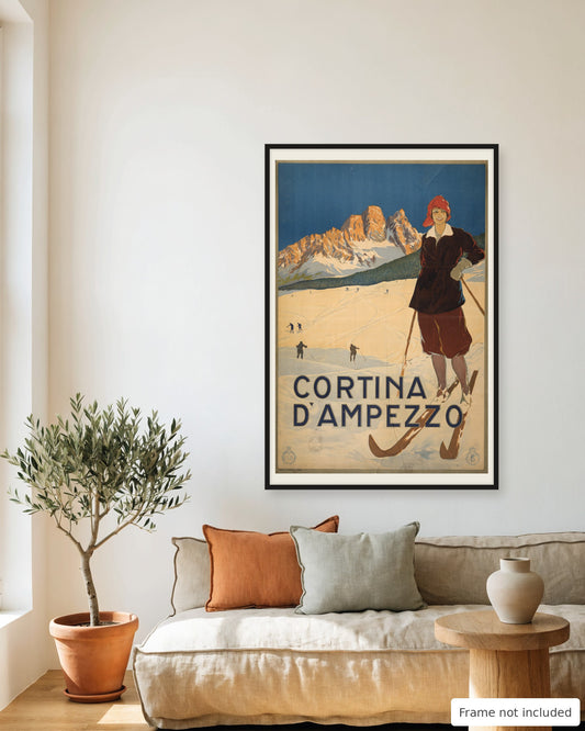 Cortina d'Ampezzo vintage travel poster (1920) framed on a living room wall above a linen sofa