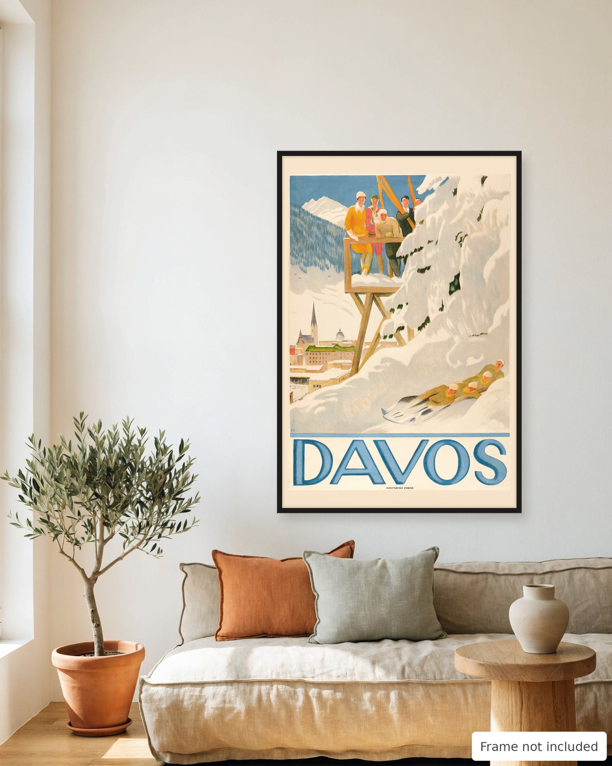 Davos vintage travel poster (1918) framed on a living room wall above a linen sofa
