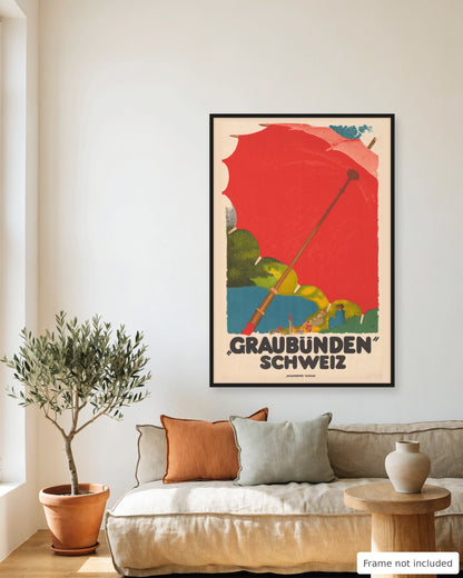 Graubunden vintage travel poster (1924) framed on a living room wall above a linen sofa