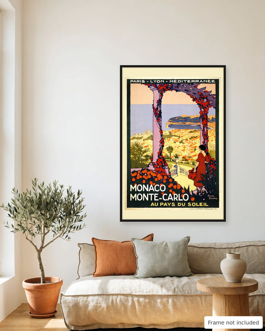 Monaco vintage travel poster (c. 1920) framed on a living room wall above a linen sofa