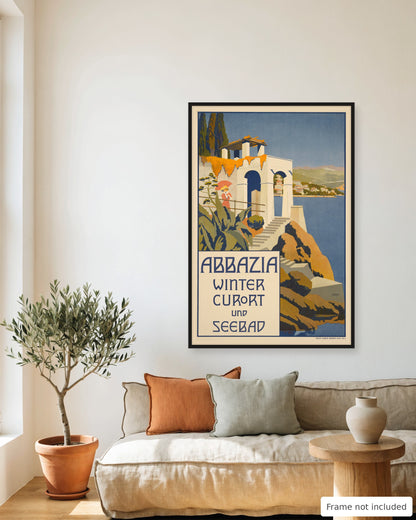 Opatija vintage travel poster (1911) framed on a living room wall above a linen sofa