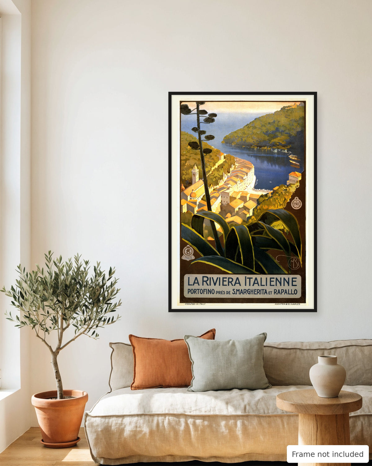 Portofino vintage travel poster (c. 1920) framed on a living room wall above a linen sofa