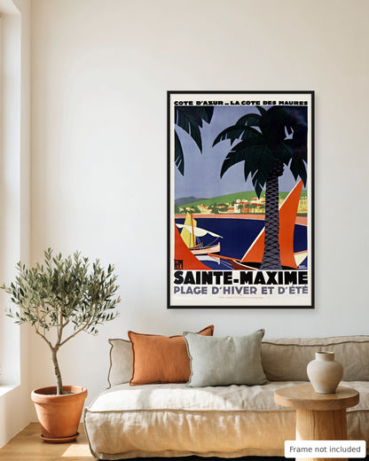 Sainte-Maxime vintage travel poster (1928) framed on a living room wall above a linen sofa