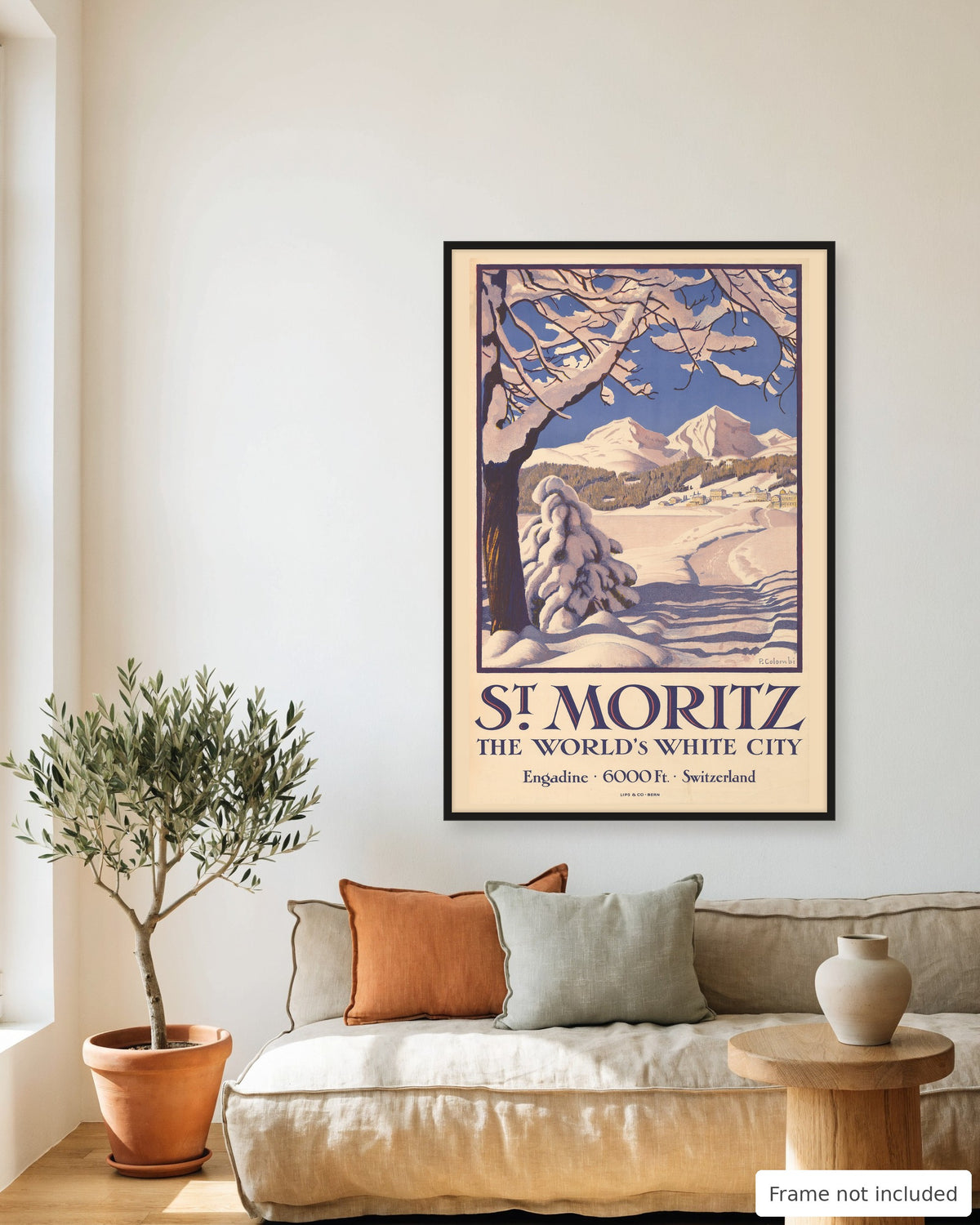 St. Moritz vintage travel poster (1929) framed on a living room wall above a linen sofa