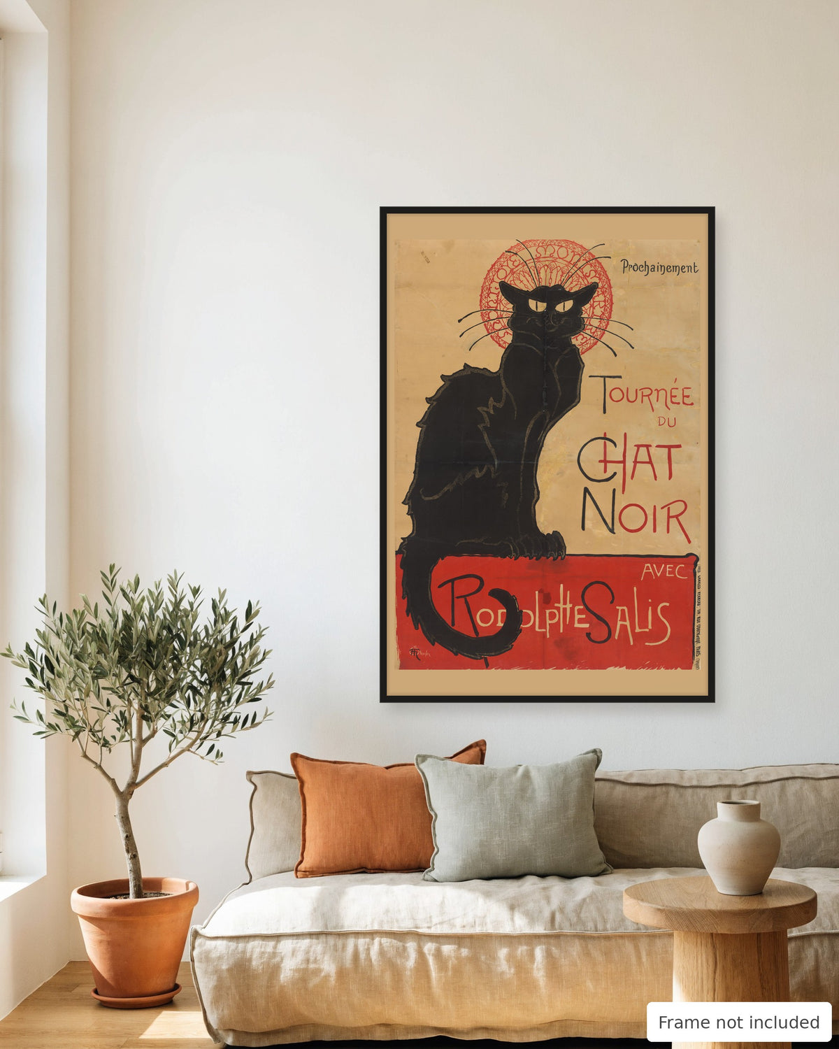 Tournée du Chat Noir black cat poster by Steinlen (1896) framed on a living room wall above a linen sofa