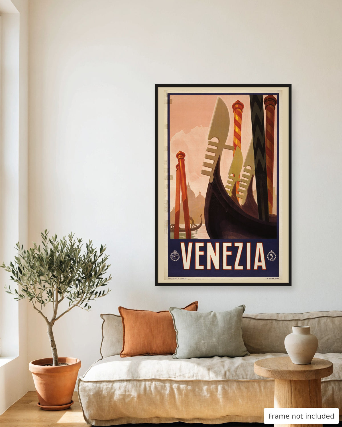 Venice vintage travel poster (1920) framed on a living room wall above a linen sofa