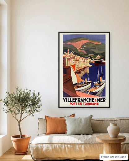 Villefranche-sur-Mer vintage travel poster (1929) framed on a living room wall above a linen sofa