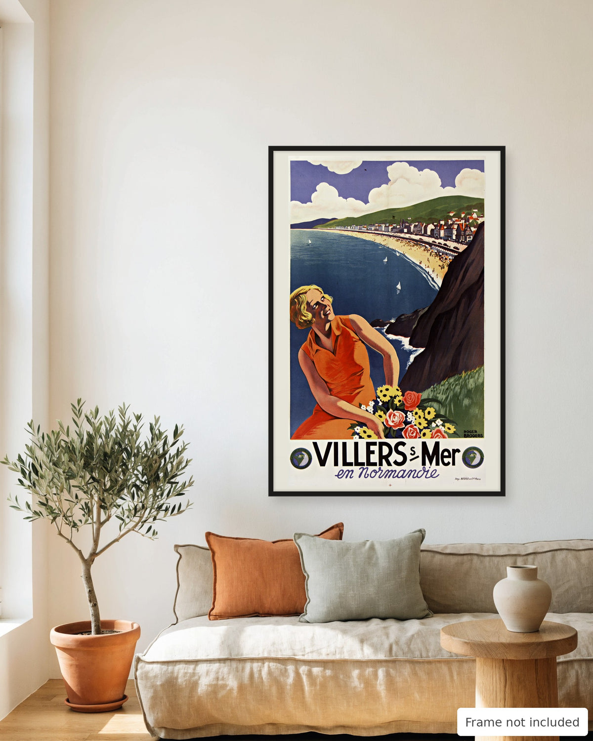 Villers-sur-Mer vintage travel poster (1920s) framed on a living room wall above a linen sofa