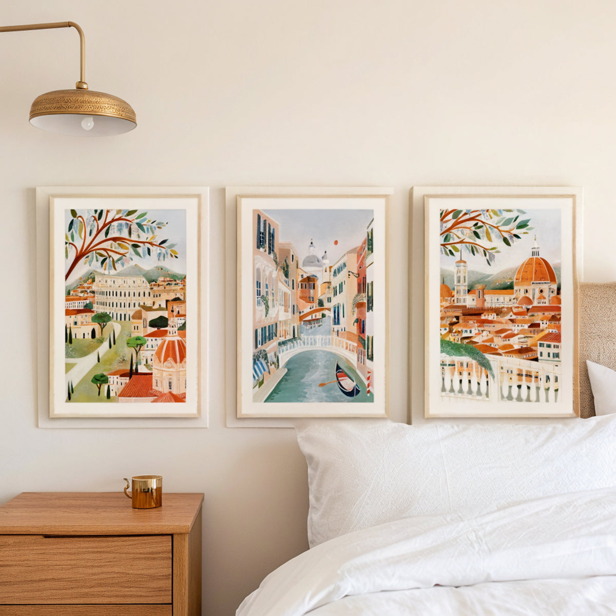 Rome Venice Florence prints above a bed in a calm Scandinavian bedroom