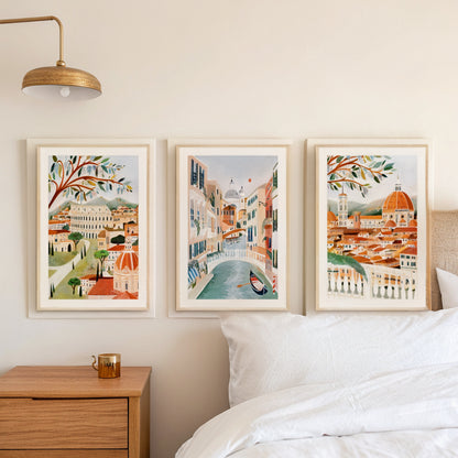Rome Venice Florence prints above a bed in a calm Scandinavian bedroom