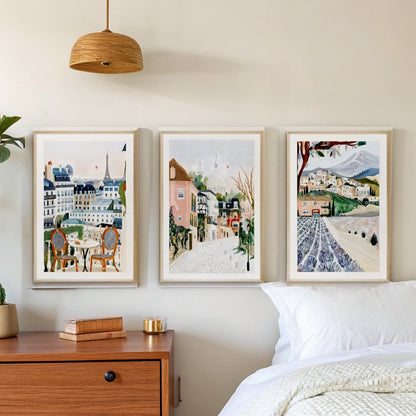 Paris Montmartre Provence prints above a bed in a calm bedroom