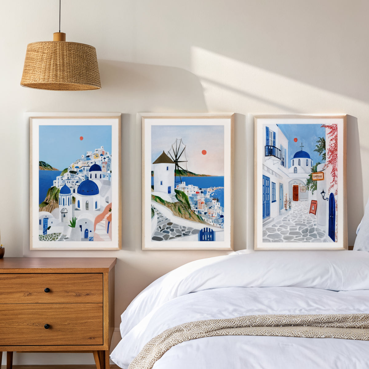 Santorini Mykonos Paros prints above a bed in a calm bedroom
