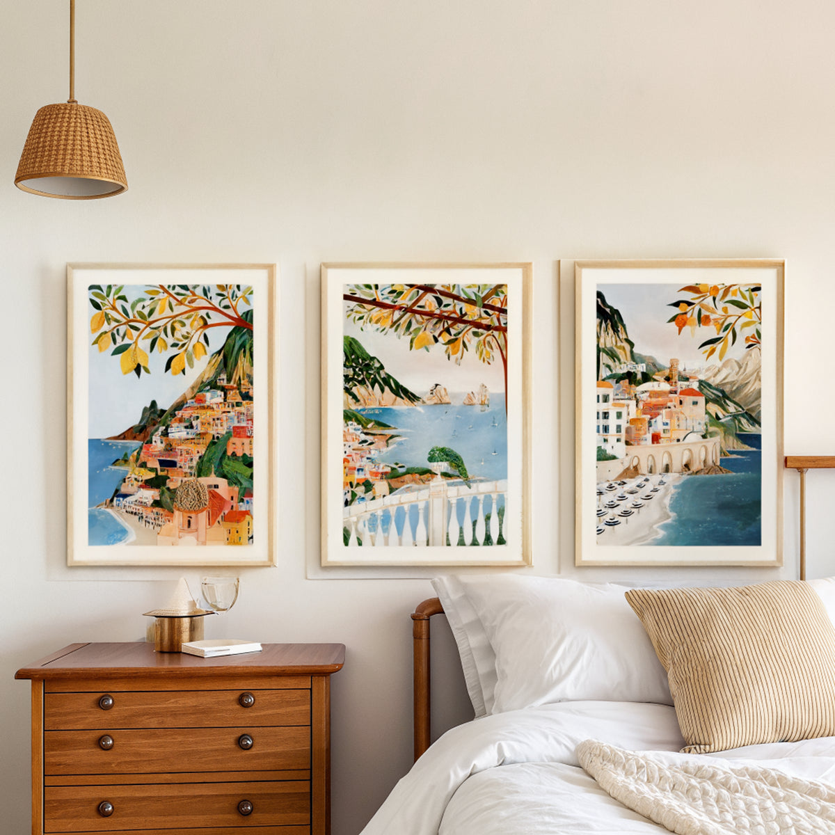 Positano Capri Atrani prints above a bed in a calm bedroom