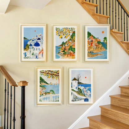 Five Mediterranean coast prints arranged on a staircase wall