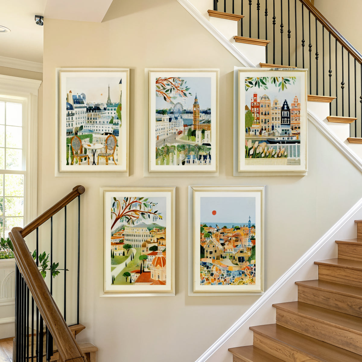 Five European city prints arranged on a staircase wall